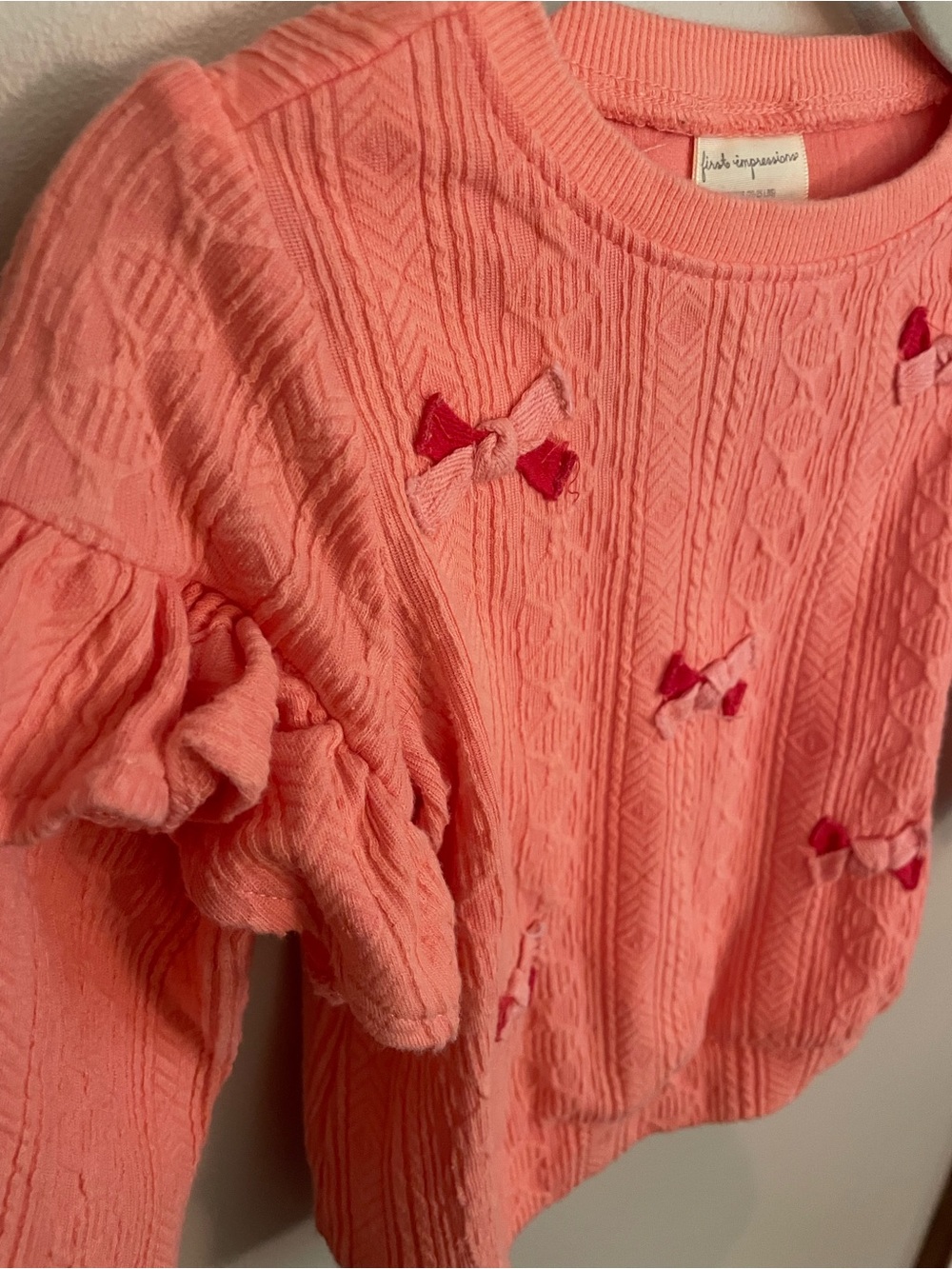 First Impressions Coral Pink Ruffle Sweater with Bow Accents